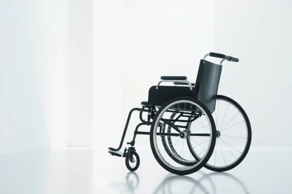 Manual wheelchair displayed in a bright room, showcasing its sleek design and features for accessibility.